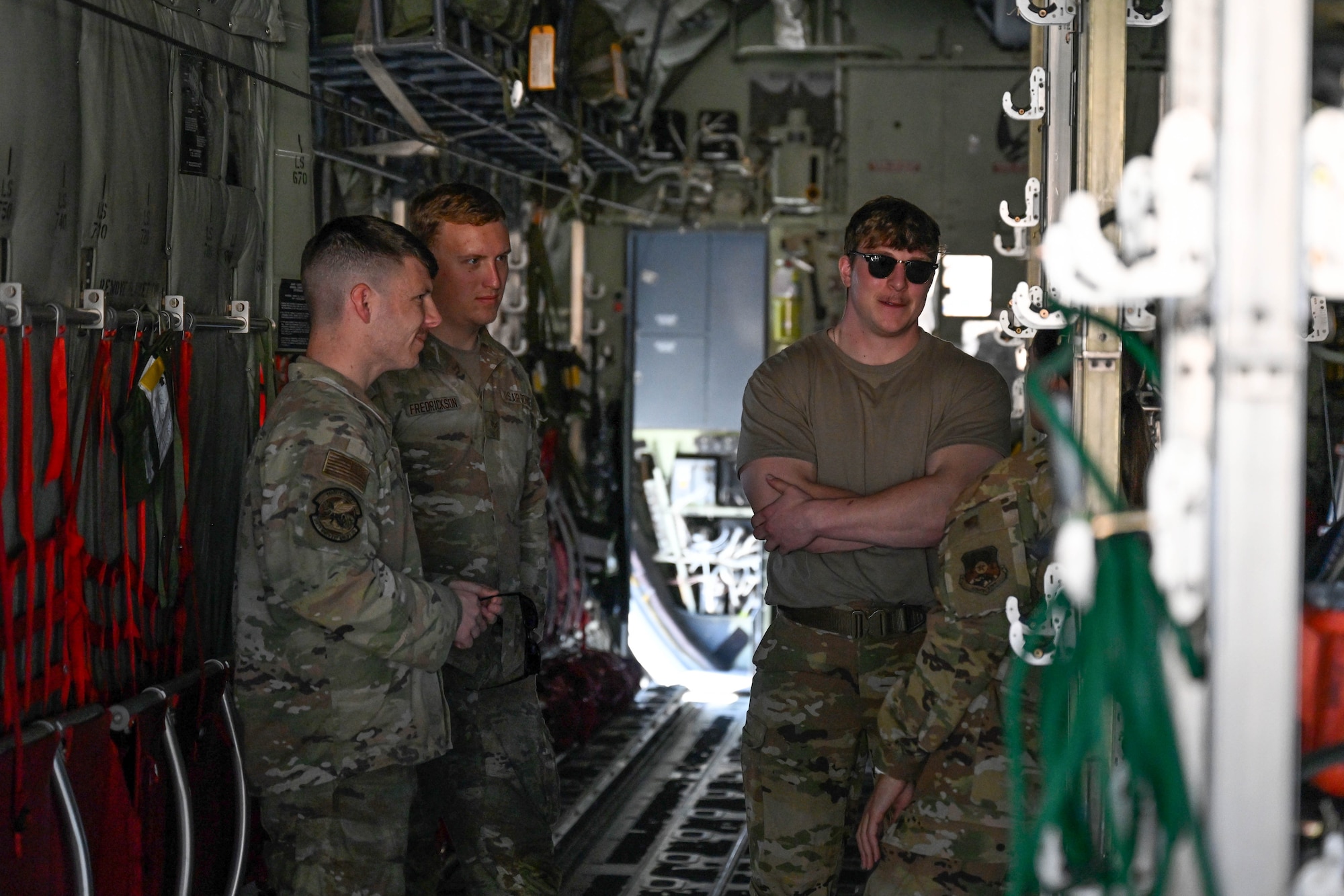 Men in uniform conversate in an aircraft.