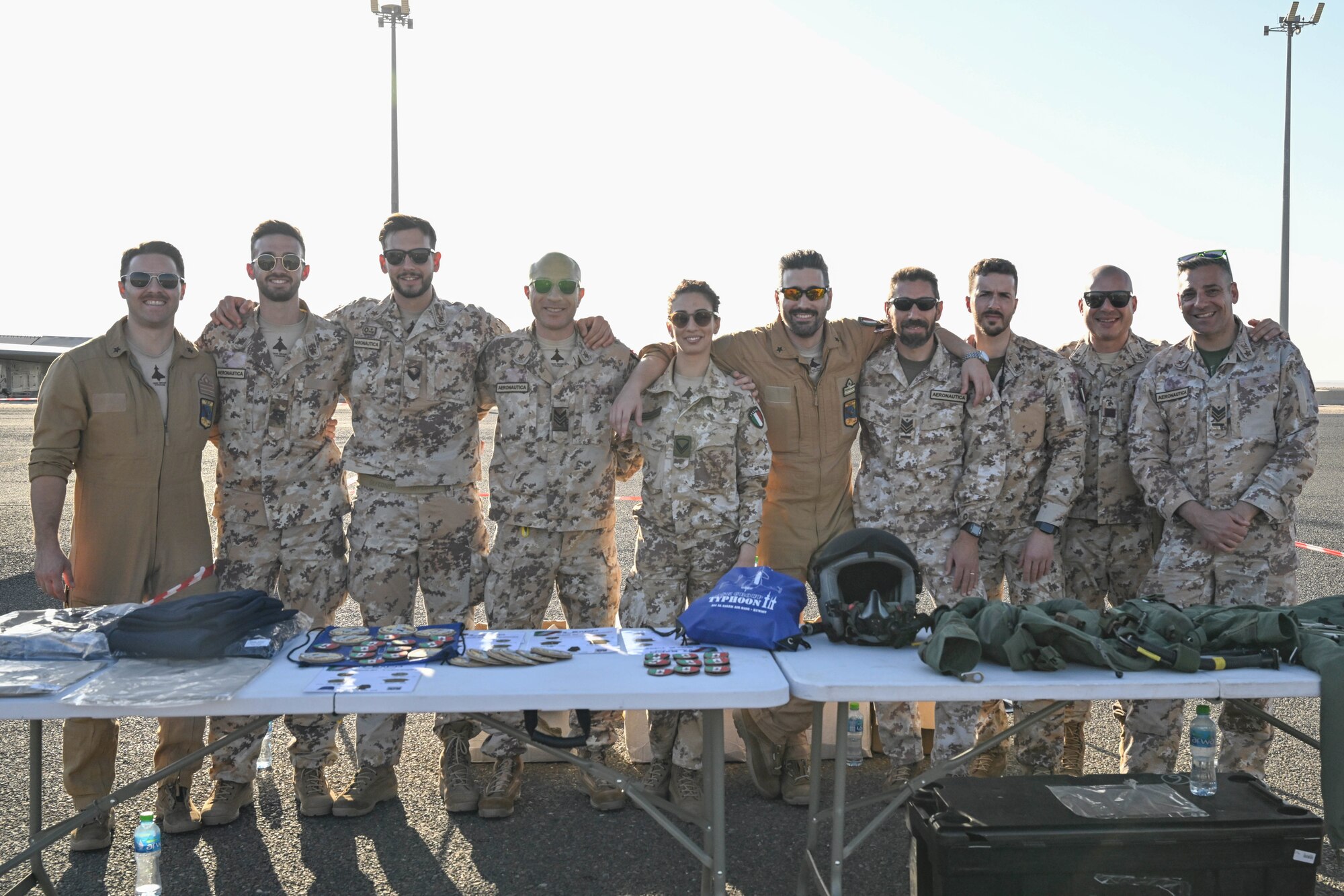 People in uniform pose for a photo.