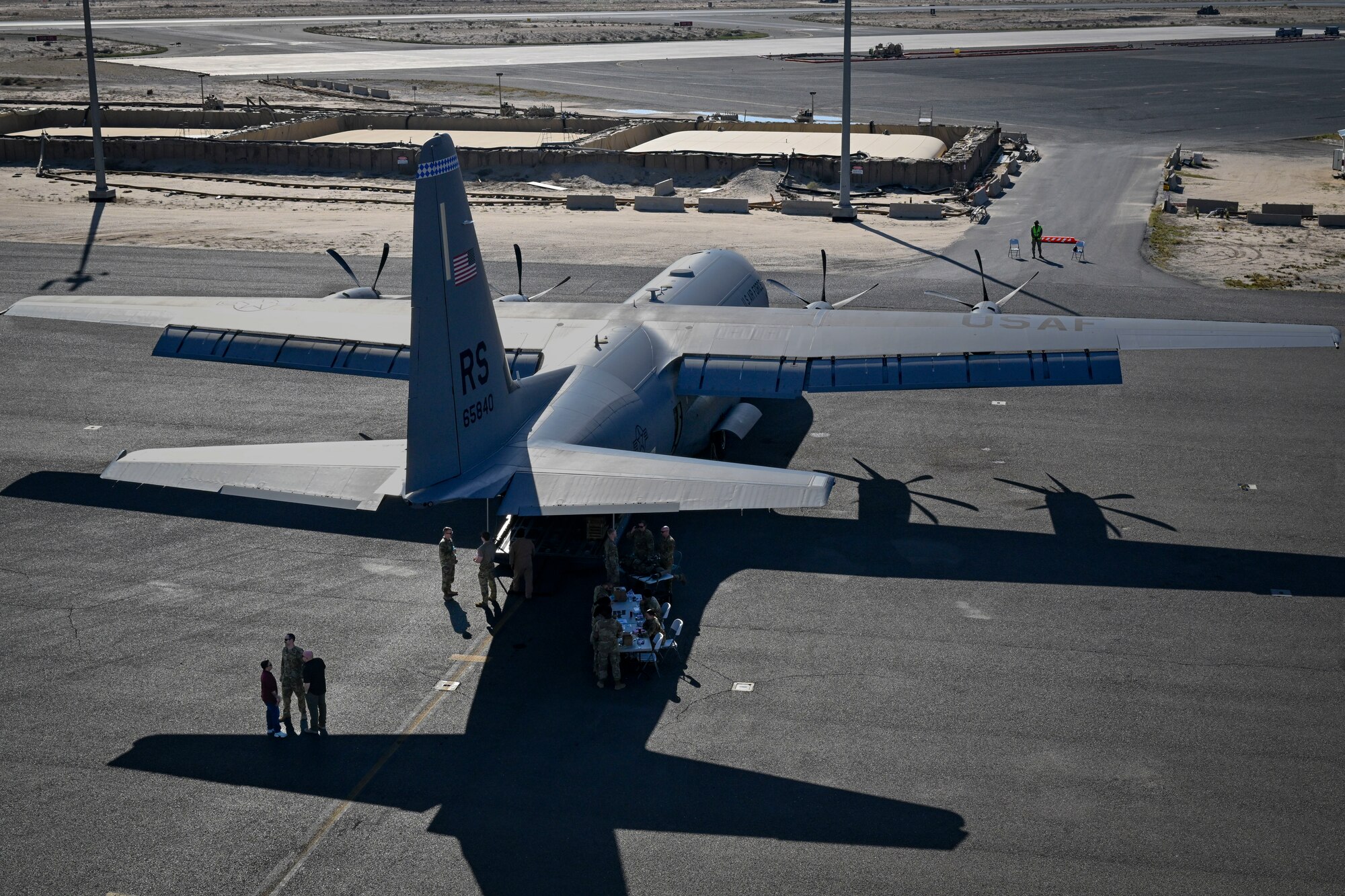 A C-130 Super Hercules aircraft sits parked on a flightline.