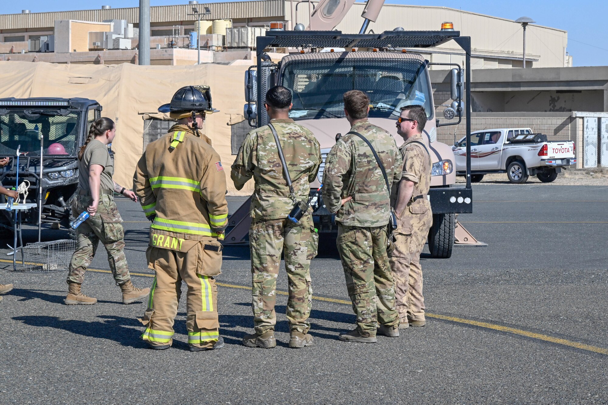 People in uniform conversate.