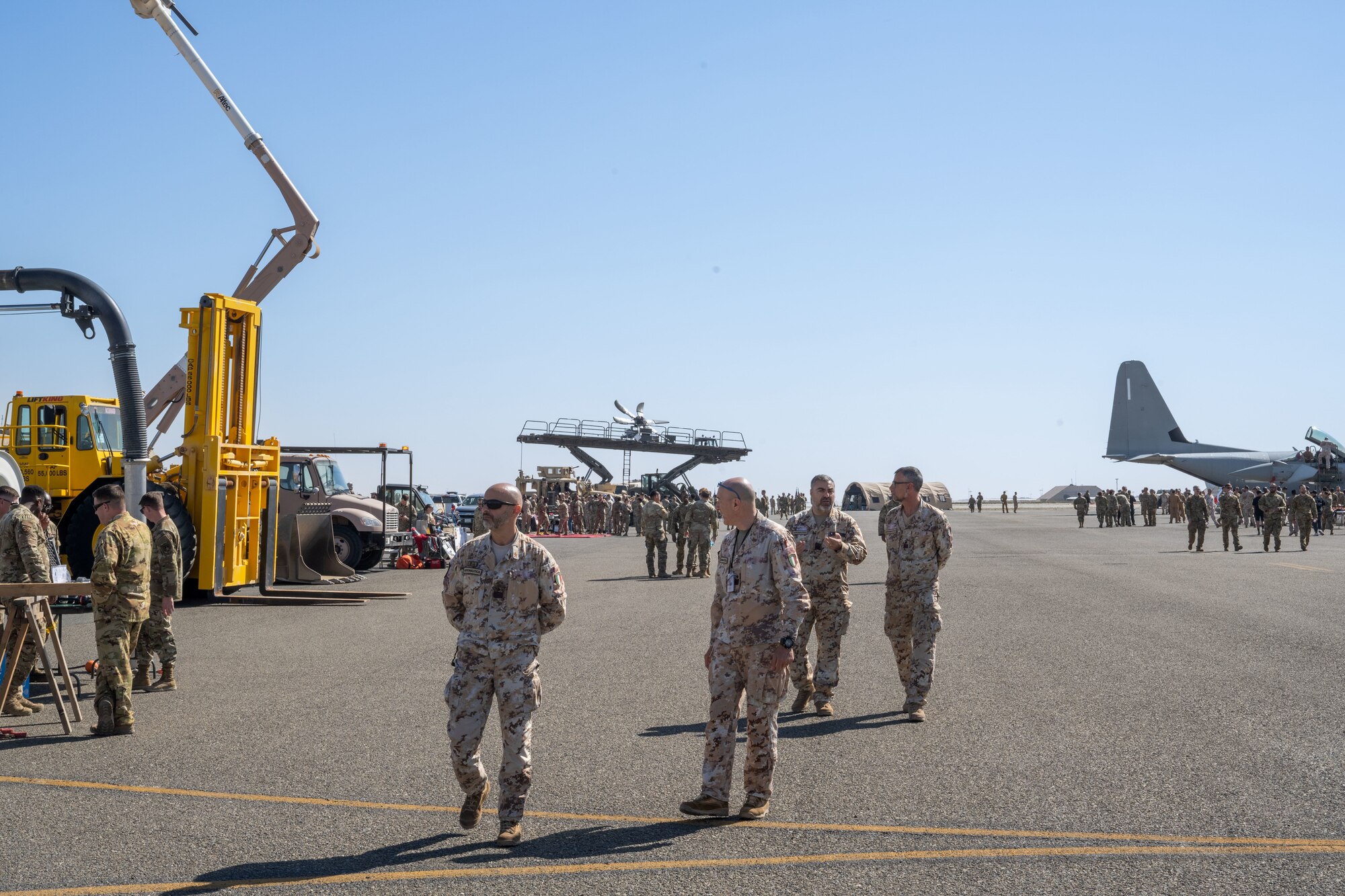 Italians in uniform walk around an air expo.