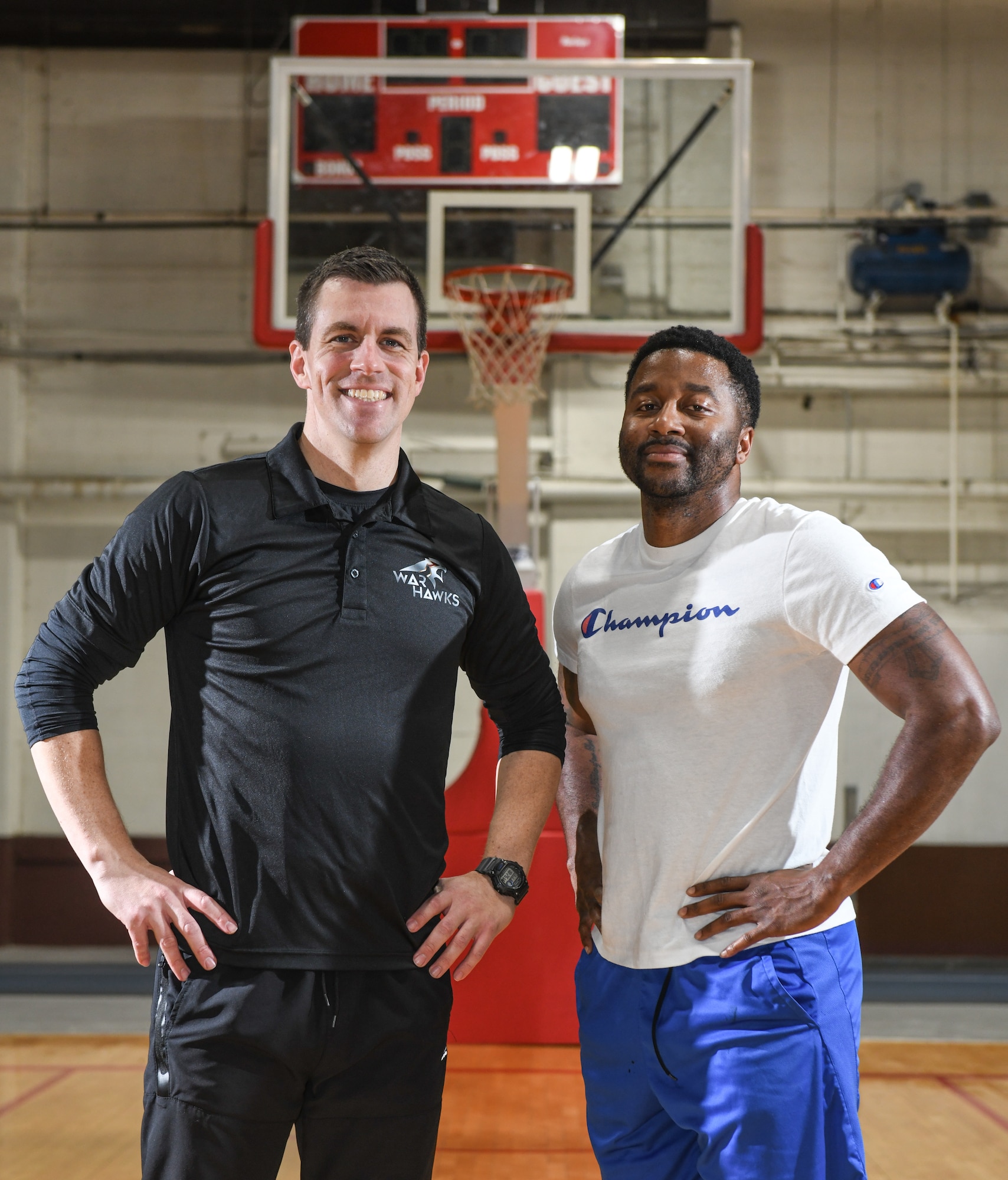 Capt. Christopher Cook, Head Coach, and Master Sgt. Derrick Raley, Team Mentor, pose for a photo at the Offutt Air Force Base Field House on March 6, 2025. Cook and Raley have been instrumental in turning the Warhawks basketball program around. (U.S. Air Force photo by Chad Watkins)