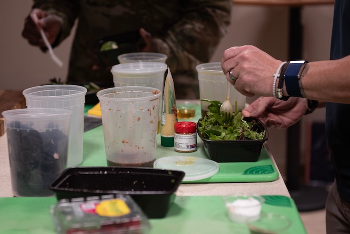 U.S. Air Force Chief Master Sgt. Thomas Gunnell, 492nd Special Operations Wing command chief, mixes a salad with homemade dressing at Hurlburt Field, Florida, Feb. 11, 2025.