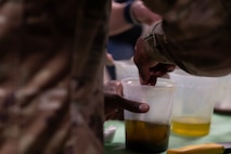 U.S. Air Force Chief Master Sgt. Ralph Oliver, 1st Special Operations Wing command chief, stirs ingredients for salad dressing at Hurlburt Field, Florida, Feb. 11, 2025.