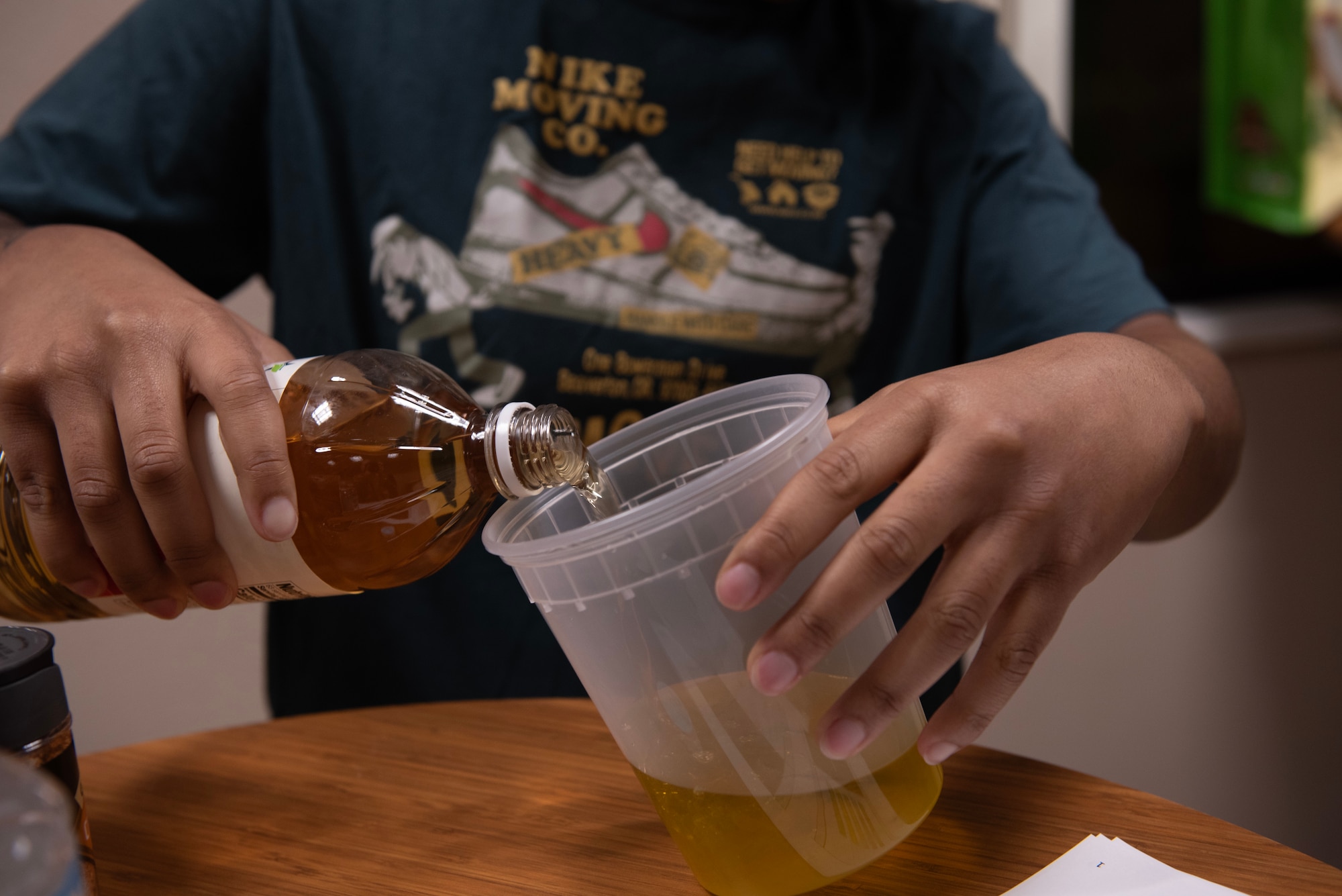 A U.S. Air Force customer service technician assigned to the 1st Special Operations Wing mixes vinegar and olive oil at Hurlburt Field, Florida, Feb. 11, 2025.