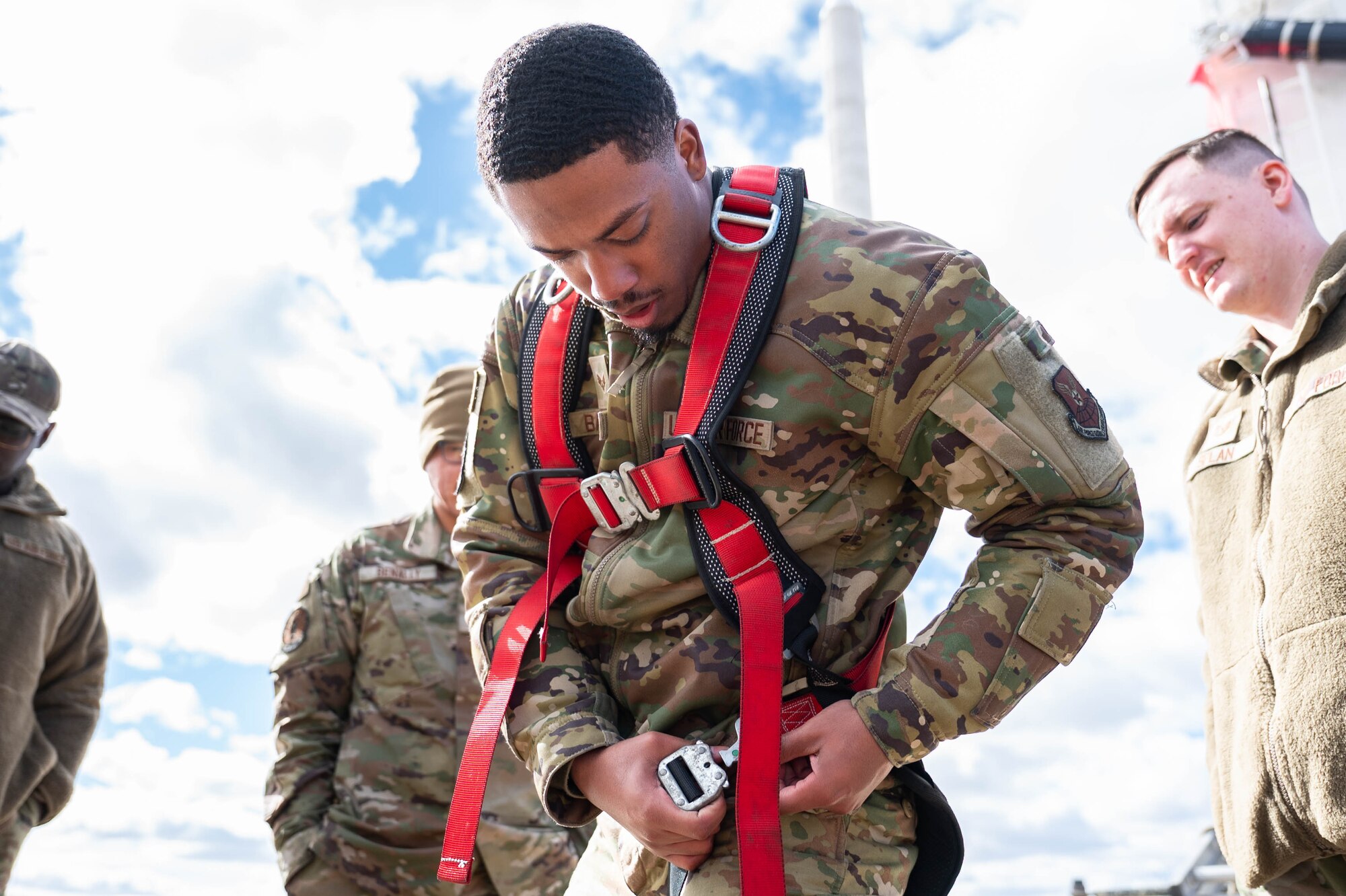 Man in uniform performs missile maintenance.