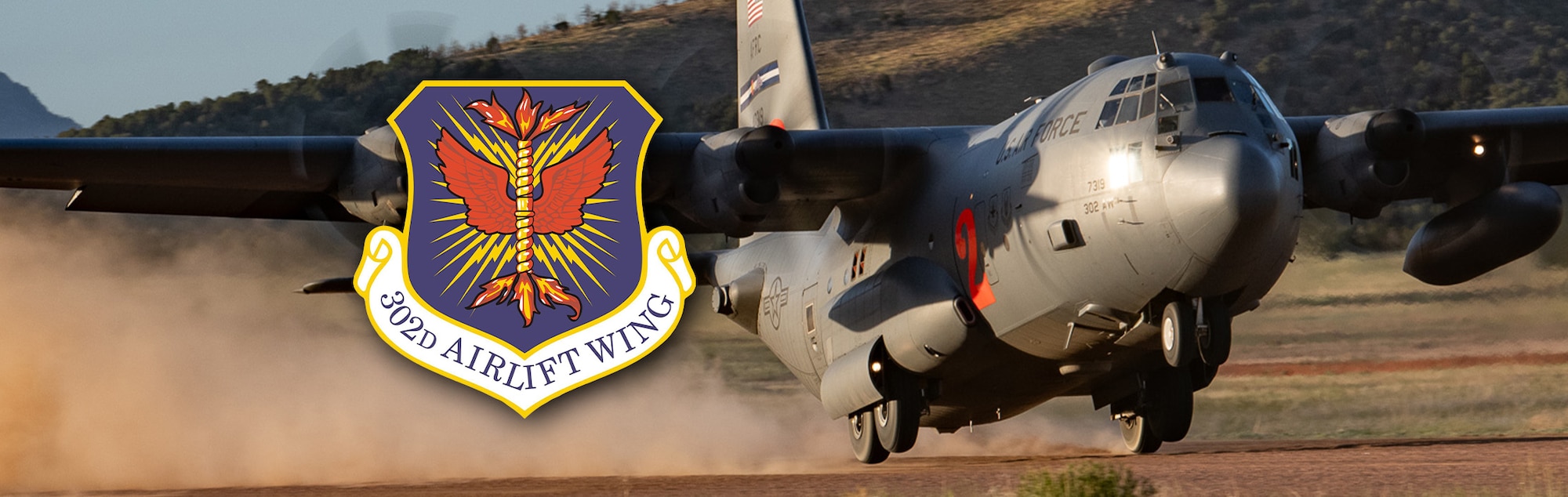 A C-130 on a dirt landing strip with the 302d Airlift Wing logo next to it.