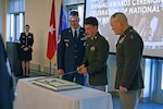 From left, Chief Master Sgt. Paul Lawrence, Pfc. Killiam MacPherson and Brig. Gen. Erik Fessenden admire their apt cake-cutting at the 2024 New Hampshire National Guard awards ceremony and birthday celebration Dec. 13, 2024, at the Edward Cross Training Complex in Pembroke. The cake cutting featured Lawrence as a stand in for the oldest guardsman, Lt. Col. Peter Degnan, and MacPherson as the youngest. The event recognized achievements of 24 soldiers, airmen and civilians and featured a commemorative cake cutting on the National Guard’s 388th birthday.