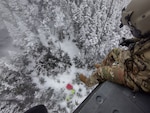 From a hover of 70 feet, Sgt. Daniel Bourque, a medevac crew member with the New Hampshire Army National Guard, lowers Sgt. 1st Class Ethan Major during a rescue operation Dec. 19, 2024, on Franconia Ridge. Photo courtesy of Sgt. 1st Class Aaron DeAngelis, NHARNG Aviation.