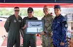 From left, Col. Nelson Perron, commander of the 157th Air Refueling Wing, Col. Pablo Soriano, chief of staff of the Salvadoran Air Force, Chief Master Sgt. Kevin Reiter, command chief of the 157th ARW, and Col. Rafael Melara, commander of the Salvadoran Air Force Academy, exchange gifts at the Ilopango Air Show in El Salvador on Feb.1, 2025. Photo courtesy of Salvadoran Air Force.