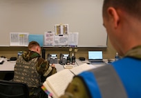 An Airman reads his notebook.