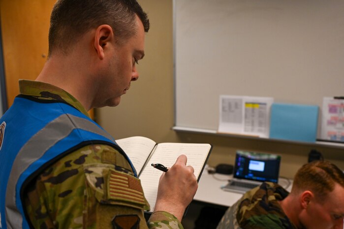 An Airman writes in a notebook.
