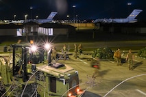 Airmen load pallets.