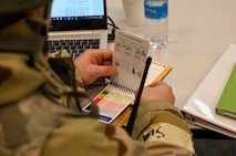 An Airman looks at a book.