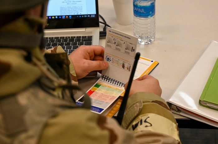 An Airman looks at a book.