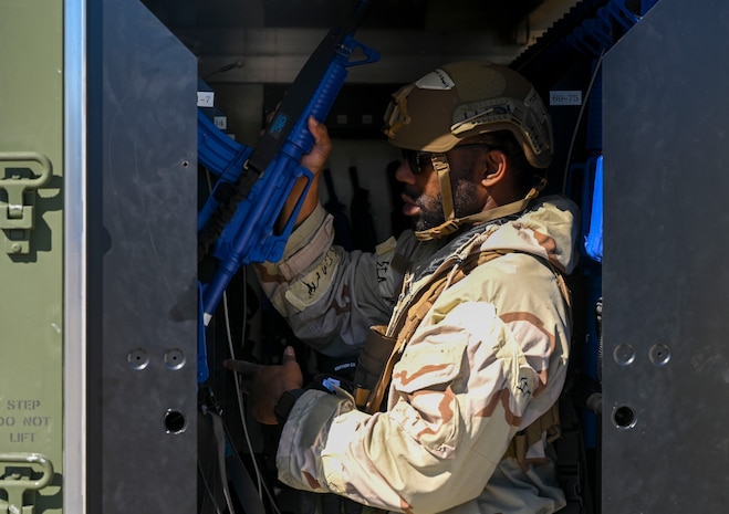 An Airman grabs a training rifle.