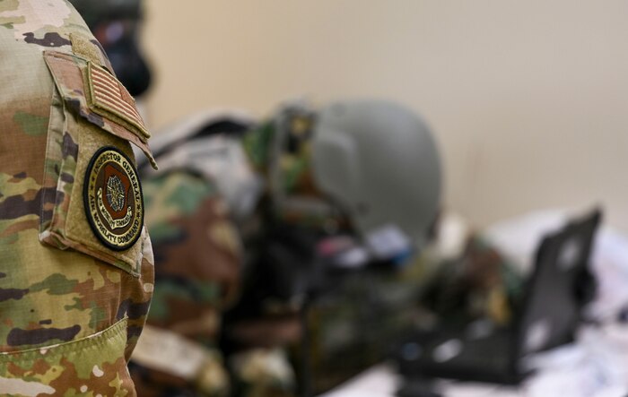 An Airman inspects another Airman.