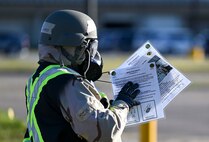 An Airmen looks over her instruction cards.