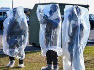 Airmen don MOPP 4 gear.