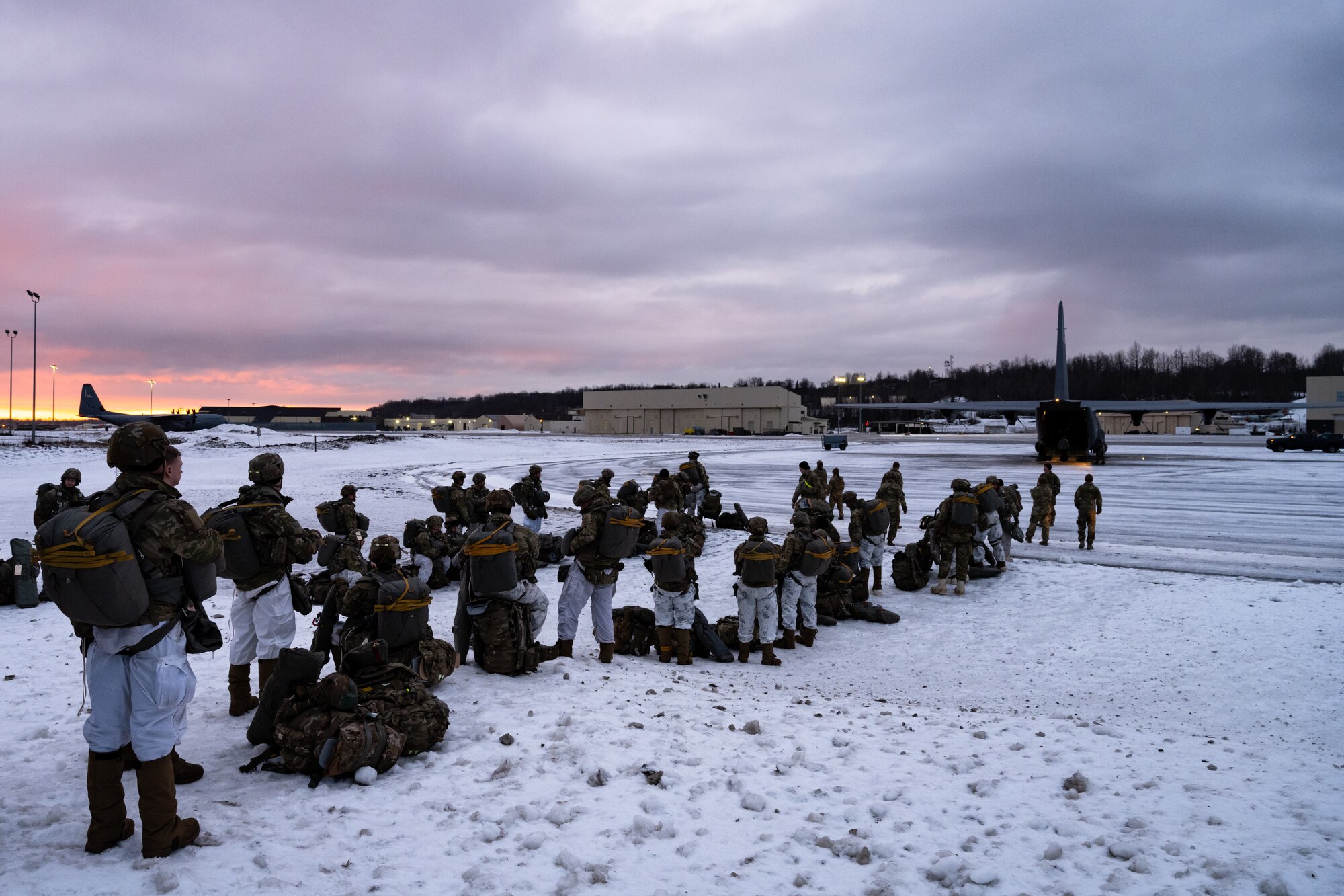 Soldiers from the 11th Airborne Division prepare to step to a C-130J Super Hercules during the Joint Pacific Multinational Readiness Center 25-02 training exercise at Joint Base Elmendorf-Richardson, Alaska, Jan. 22, 2025. The 40th AS coordinated 11th AD airdrops into simulated objective areas for a ground exercise in extreme cold weather conditions, continuing an 80-year-long relationship for exercises in the Indo-Pacific. (U.S. Air Force photo by Airman 1st Class Jade M. Caldwell)