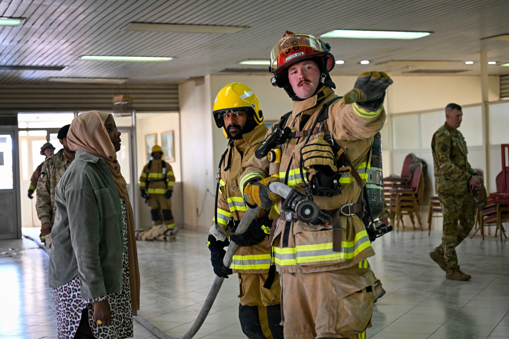 Two firefighters simulate fire training.