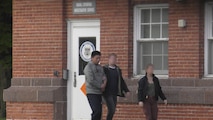 NCIS Special Agents escort Pang after arresting him for plotting to attack Naval Station Great Lakes.