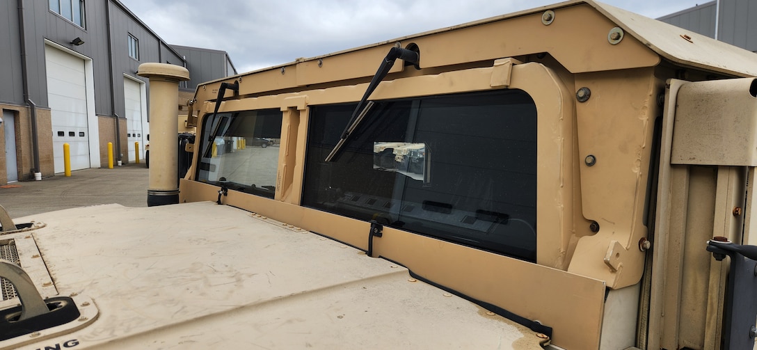 Close up photo of a tan HMMWV windshield
