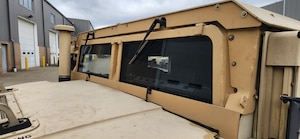 Close up photo of a tan HMMWV windshield