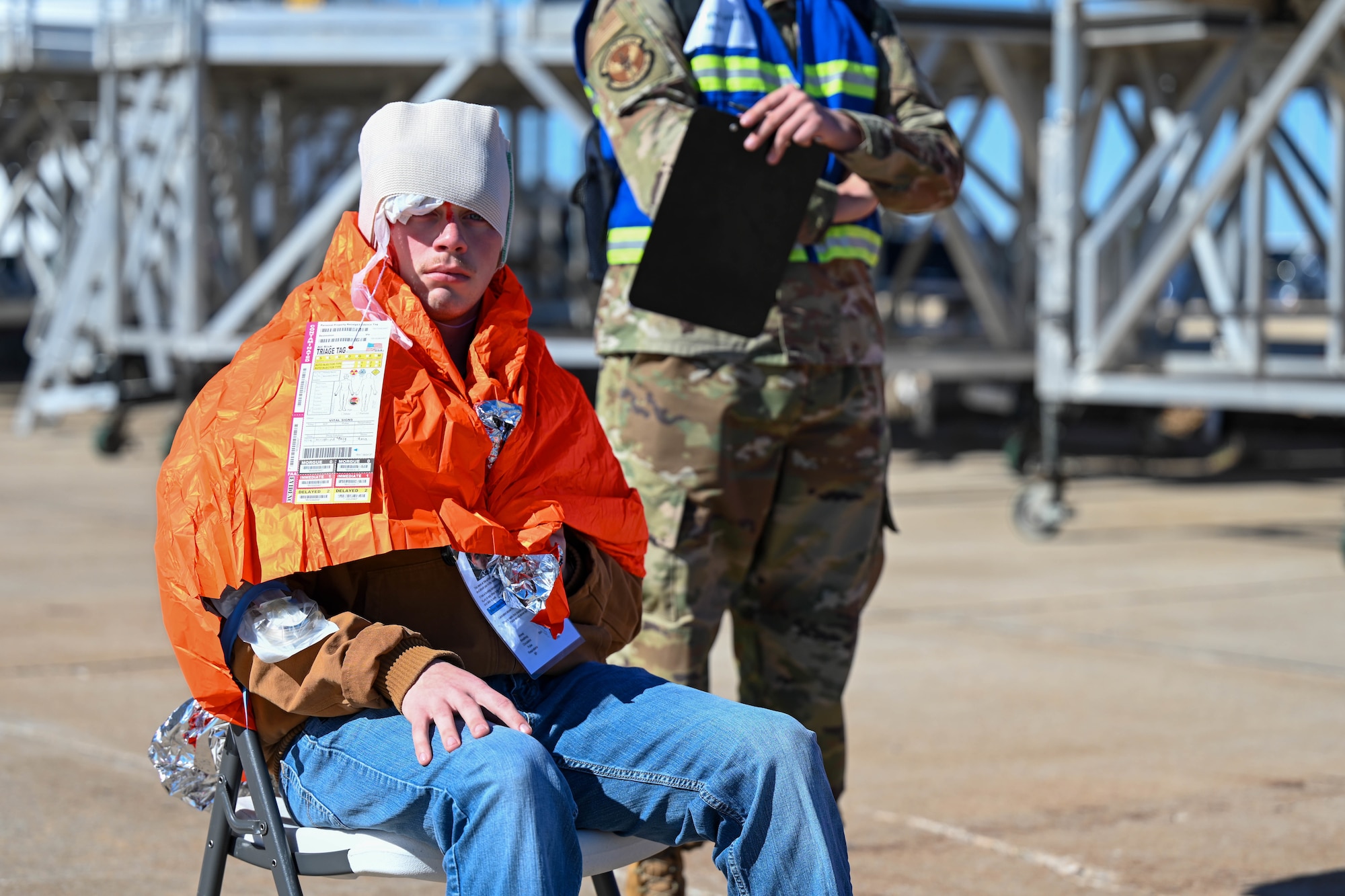 U.S. Air Force Airman 1st Class Spain Bryce, 97th Training Squadron C-17 loadmaster student, represents a wounded person in a Sustainment Operations for Air Force Medical Responders training scenario at Altus Air Force Base, Oklahoma, Feb. 27, 2025.