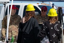 Two Airmen speak to two local students during Construction Career Day.