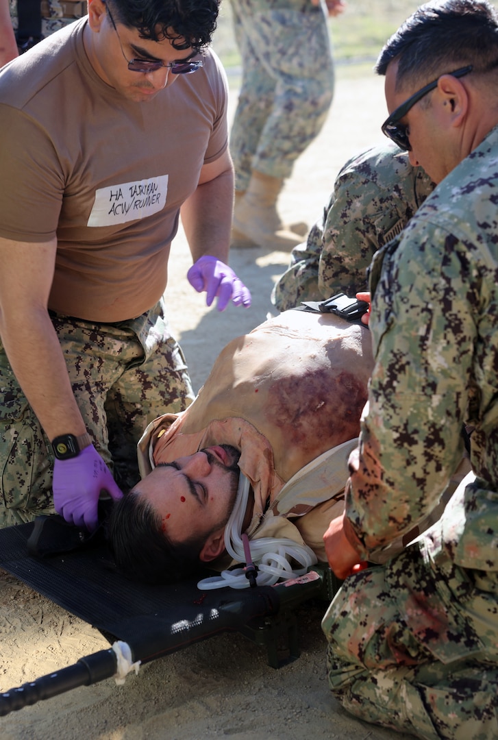 Medical personnel with Expeditionary Medical Facility (EMF) 150-Alpha receive a live actor patient wearing a surgical “cut suit” with iliac artery and bowel injury, and a right leg amputation, mimicking trauma caused by an improvised explosive device (IED) explosion, during an EMF training and Operational Readiness Evaluation (ORE) conducted at Naval Expeditionary Medicine Warfighter Development Center (NEMWDC), Camp Pendleton, Calif., Feb. 15-28. "We continue to emphasize a “train as you fight, fight as you train” mentality,” said Cmdr. Damian Storz, executive officer of NEMWDC. “The patient scenarios focused on battle injury patient casualties but also included non-battle injuries to test multiple aspects of care.