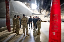 Airmen from the 5th Maintenance Group guide a tour about the outside of a B-52H Stratofortress to the Minot State University Track & Field Team at Minot Air Force Base, North Dakota, March 4, 2025. The tour group consisted of students from North Dakota, out of state and even international students. (U.S. Air Force photo by Senior Airman Kendra A. Ransum)
