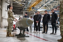 A member of the 5th Maintenance Group presents about conventional munitions to Minot State University Track & Field Team students at Minot Air Force Base, North Dakota, March 4, 2025. The 5 MXG supports the dynamic operations of both the 5th Bomb Wing and 91st Missile Wing (U.S. Air Force photo by Senior Airman Kendra A. Ransum)