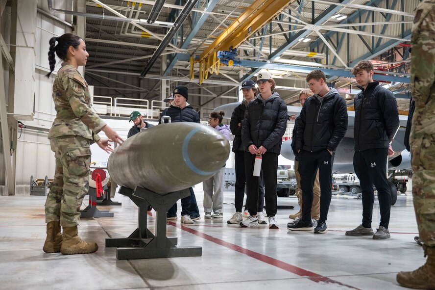 A member of the 5th Maintenance Group presents about conventional munitions to Minot State University Track & Field Team students at Minot Air Force Base, North Dakota, March 4, 2025. The 5 MXG supports the dynamic operations of both the 5th Bomb Wing and 91st Missile Wing (U.S. Air Force photo by Senior Airman Kendra A. Ransum)
