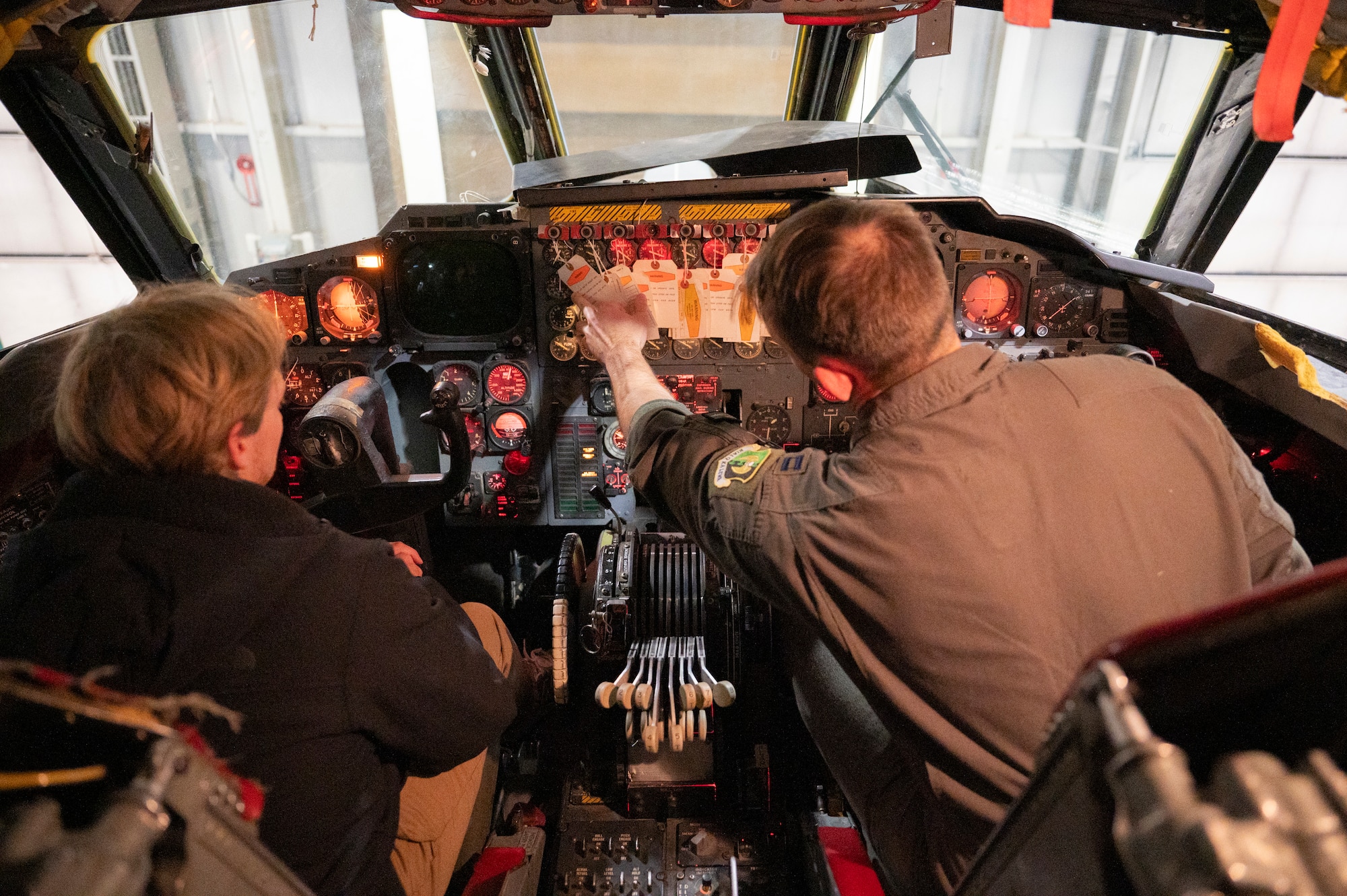 A 23rd Bomb Squadron aircrew member explains the B-52H Stratofortress to a Minot State University Track & Field Team student at Minot Air Force Base, North Dakota, March 4, 2025. The tour was provided to Minot State University Track & Field Team students and coaches. (U.S. Air Force photo by Senior Airman Kendra A. Ransum)