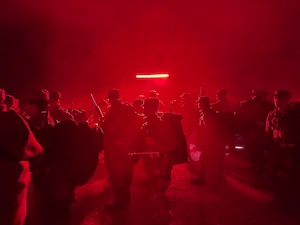Trainees line up under the red light at the start of PACER FORGE