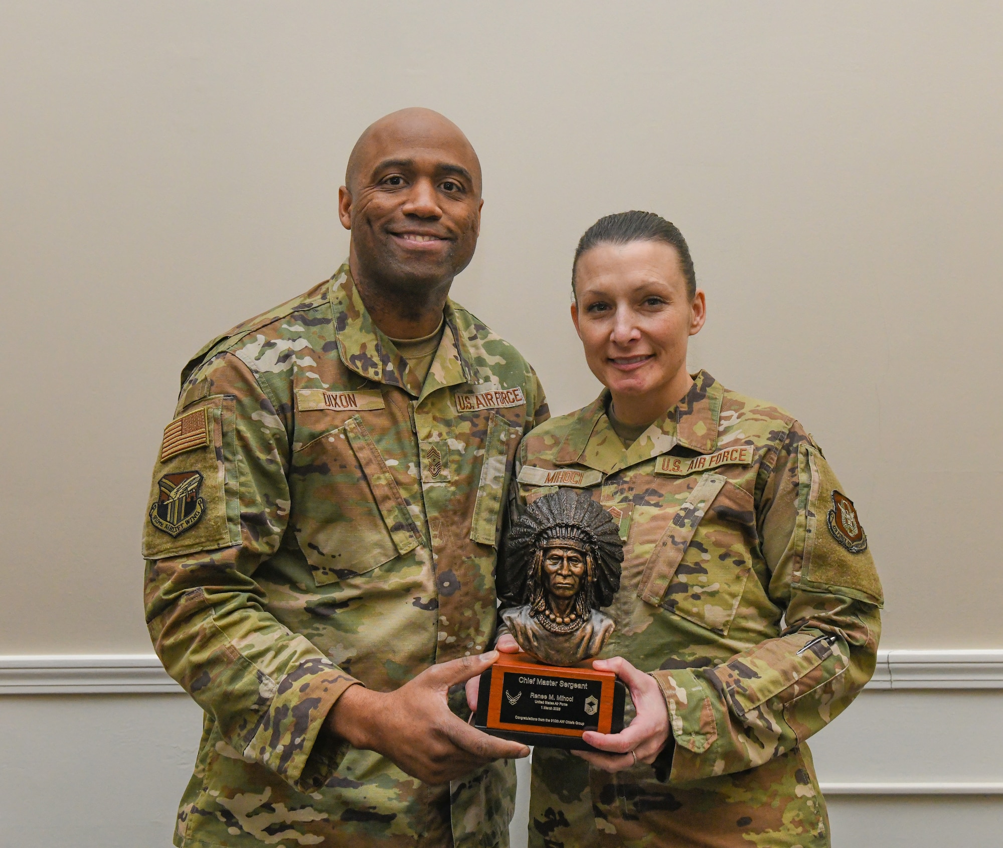 Chief Master Sgt. Howard Dixon, 910th Airlift Wing command chief, gives Chief Renee Mihoci, 910th Force Support Squadron senior enlisted leader, a Chief’s bust during her promotion ceremony at Youngstown Air Reserve Station, Ohio, Mar. 2, 2025.