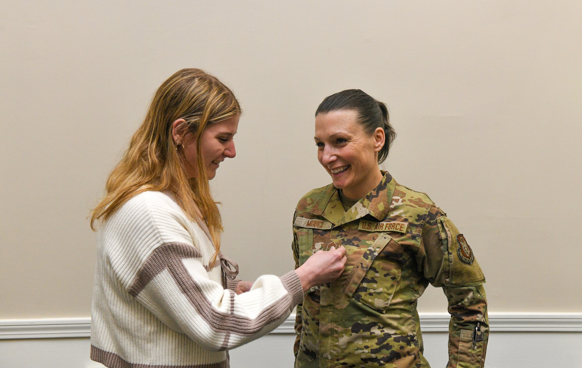 Chief Master Sgt. Renee M. Mihoci, 910th Force Support Squadron senior enlisted leader, laughs with a family member during her promotion ceremony at Youngstown Air Reserve Station, Ohio, Mar. 2, 2025