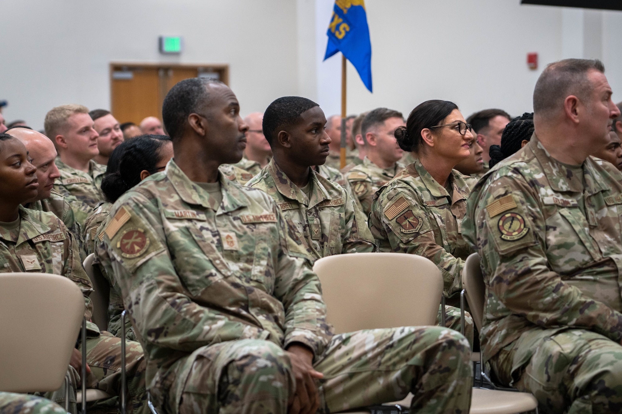Airmen sitting in commanders call