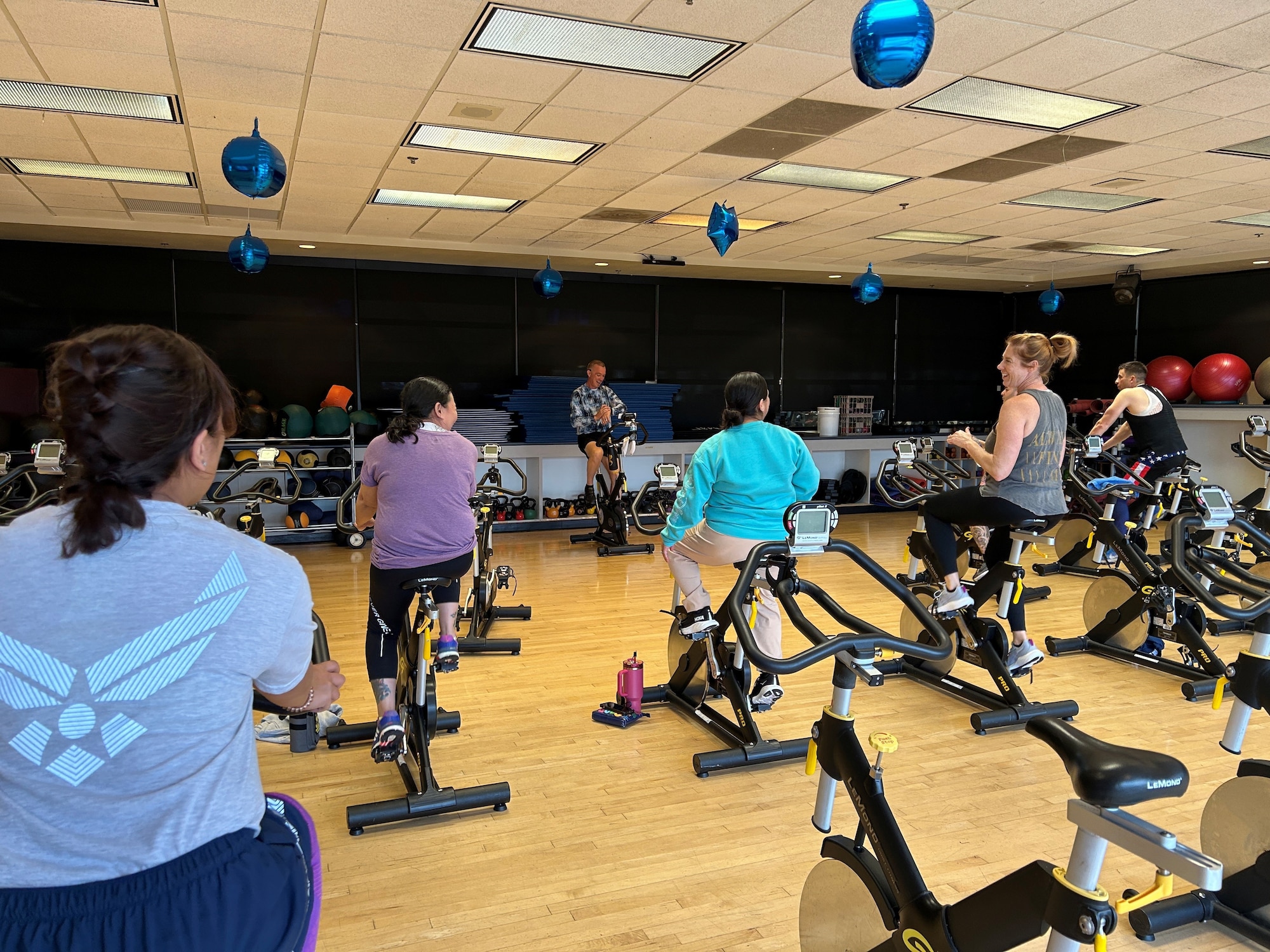 Airman on spin bikes for a fitness class taught by Lt. Col. Hale, 349th Mission Support Group commander.
