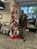 U.S. Army Soldier in uniform poses with office Christmas Tree