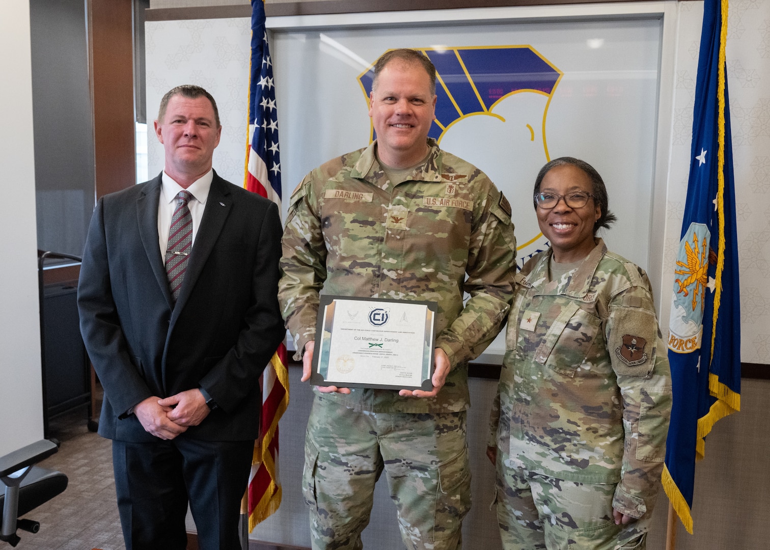 Mr. Scot Murphy, Brig. Gen. Gwendolyn Foster, and Col. Matthew Darling pose for a photo after Darling received his Continuous Improvement Green Belt certification at Wilford Hall Ambulatory Surgical Center, Joint Base San Antonio-Lackland, Texas, March 7, 2025.