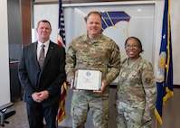 Mr. Scot Murphy, Brig. Gen. Gwendolyn Foster, and Col. Matthew Darling pose for a photo after Darling received his Continuous Improvement Green Belt certification at Wilford Hall Ambulatory Surgical Center, Joint Base San Antonio-Lackland, Texas, March 7, 2025.