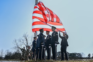 Base honor guard members prepare to fold the U.S. flag during an Air Force Assistance Fund (AFAF) retreat ceremony at Little Rock Air Force Base, Arkansas, March 7, 2025. The AFAF campaign runs annually, giving Airmen the opportunity to support their own through charitable donations.