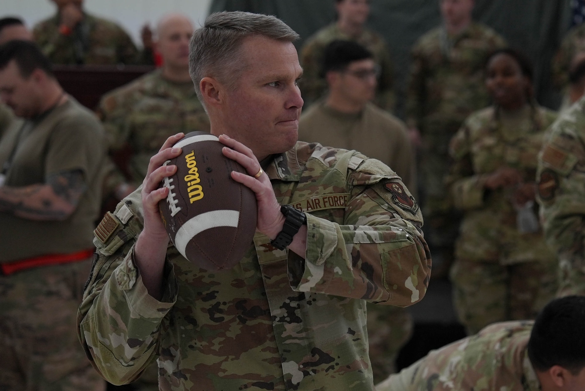 U.S. Air Force Col. Stuart Churchill, 27th Special Operations Mission Support Group commander, prepares to throw a football during a game at the Maintenance Professional of the Year ceremony at Cannon Air Force Base, New Mexico, March 7, 2025. Maintenance professionals have a hand in every operation conducted by Air Force Special Operations Command, driving innovation and solving problems for the joint force. (U.S. Air Force photo by Staff Sgt. Kevin Williams)
