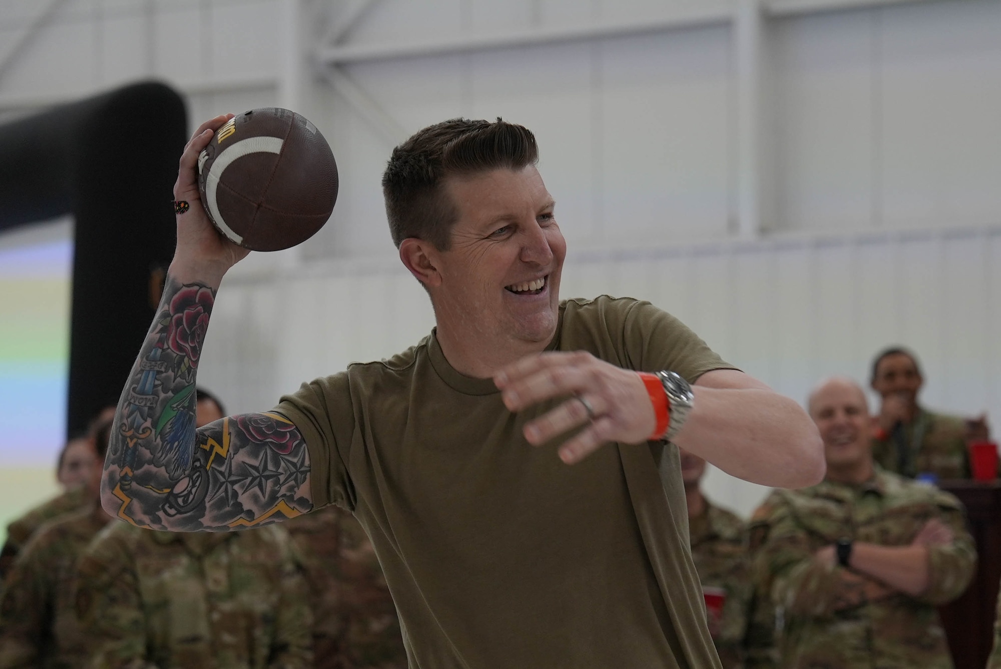 U.S. Air Force Col. Bryan Hogan, 27th Special Operations Wing deputy commander for sustainment, throws a football during a game at the Maintenance Professional of the Year ceremony at Cannon Air Force Base, New Mexico, March 7, 2025. MPOY is an opportunity to highlight the high standards and readiness of maintenance Air Commandos. (U.S. Air Force photo by Staff Sgt. Kevin Williams)