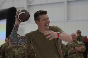 U.S. Air Force Col. Bryan Hogan, 27th Special Operations Wing deputy commander for sustainment, throws a football during a game at the Maintenance Professional of the Year ceremony at Cannon Air Force Base, New Mexico, March 7, 2025. MPOY is an opportunity to highlight the high standards and readiness of maintenance Air Commandos. (U.S. Air Force photo by Staff Sgt. Kevin Williams)