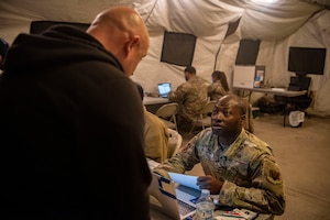 U.S. Air Force Tech. Sgt. Francis Atchoe, 51st Force Support Squadron augmentee right, in-processes an augmentee for exercise Freedom Shield 25 at Osan Air Base, Republic of Korea, March 1, 2025.