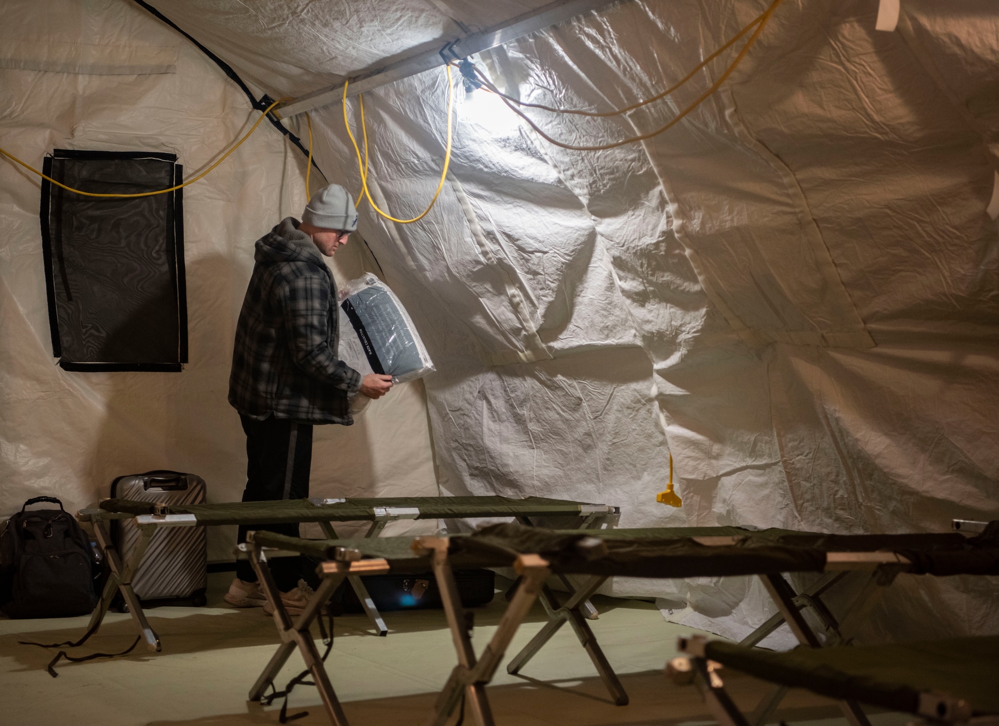 U.S. Air Force Senior Airman Gaberiel Smith, Pacific Air Simulation Center targeting analyst, unpacks his luggage in contingency lodging at Osan Air Base, Republic of Korea, March 1, 2025