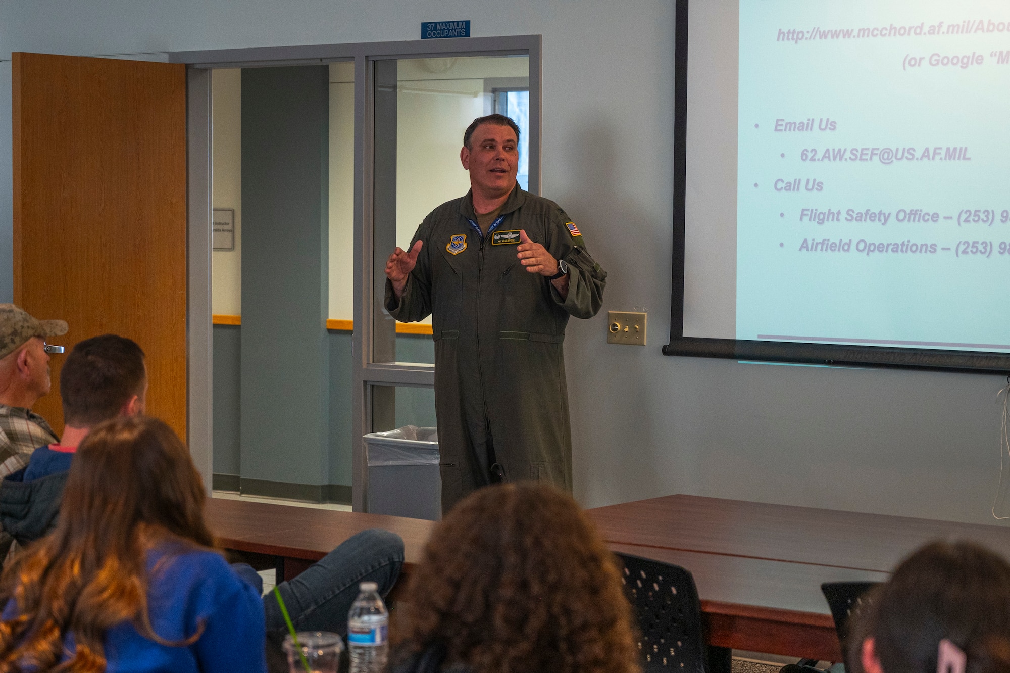 U.S. Air Force Col. Patrick McClintock, 62d Operations Group commander, gives closing remarks during a midair collision avoidance brief given to Big Bend Community College aviation program students in Moses Lake, Washington, March 7, 2025.
